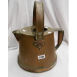 A copper hot water jug with swing and fixed handles