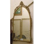 A brass framed arched top mirror in the Victorian style