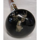 A walking cane with inset stag's head to resin finial