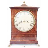 A Regency mahogany and gilt metal cased bracket clock with 7 3/4" painted domed dial, the associated