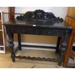 A 3' 6" 19th Century ebonised oak side table with lion mask to raised back and decorative deep