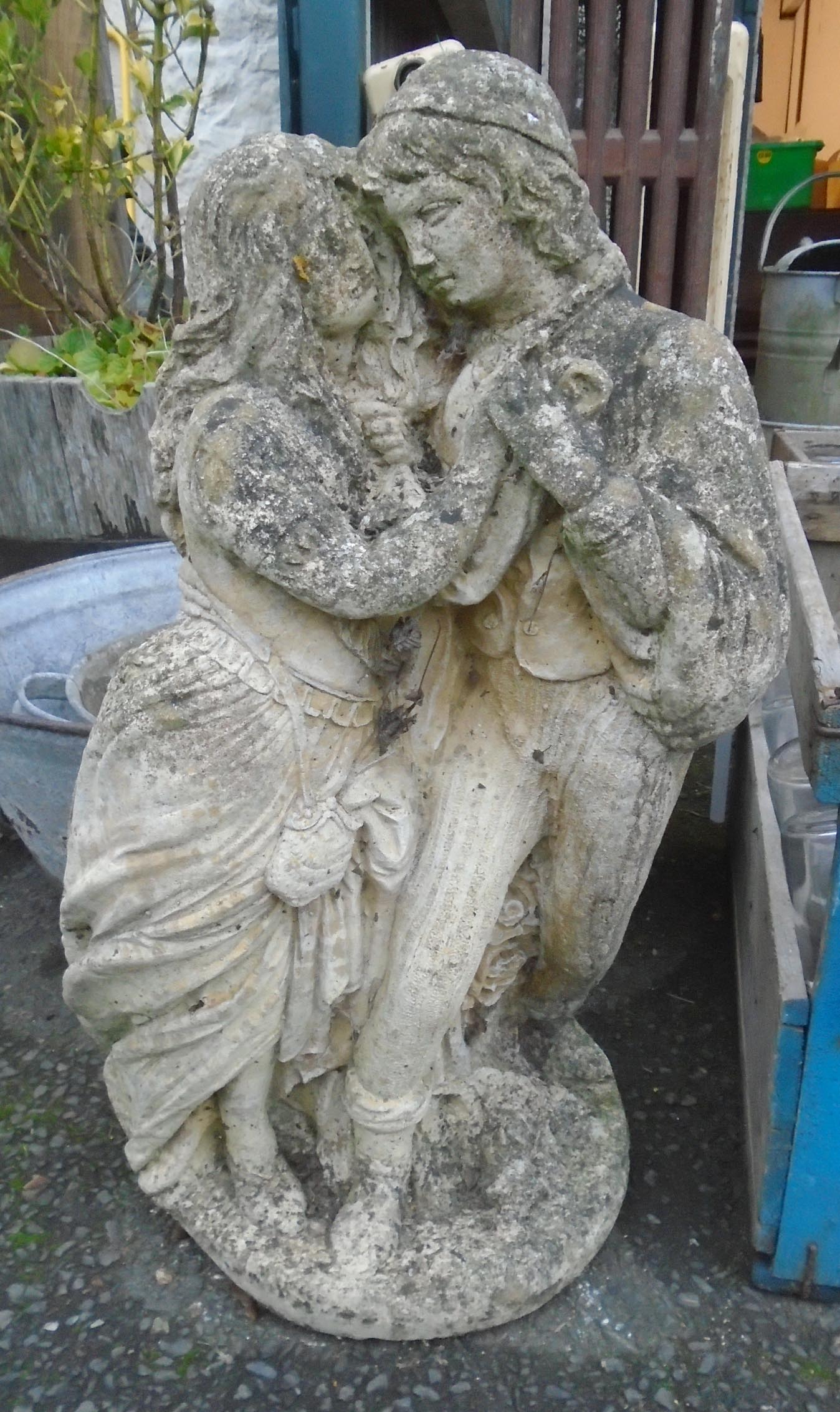 A 26" concrete garden statue in the form of a courting couple