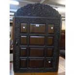 A 28" 19th Century wall hanging corner cabinet with profuse carved floral scroll and bird decoration