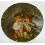 A 9" diameter late Victorian plate with hand painted scene of a boy and girl beneath a tree,