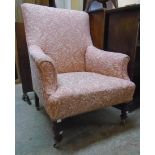 A Victorian style small armchair with foliate scroll tapestry upholstery, set on turned front legs