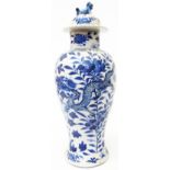 A 14 1/2" high Chinese temple jar with lion finial to lid and dragon and floral decoration,