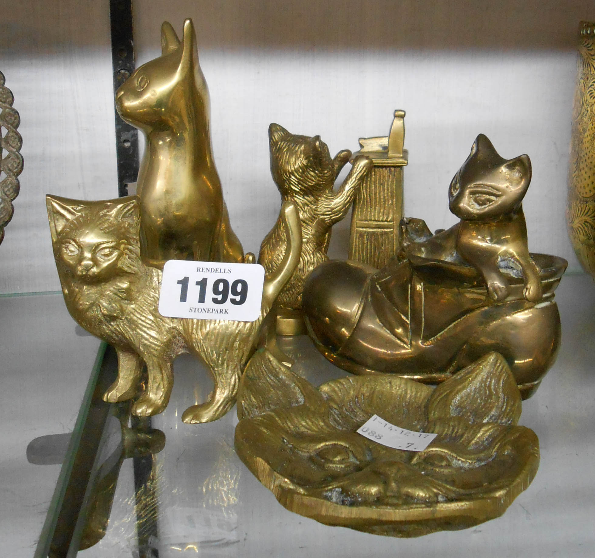 A collection of brass cat ornaments