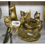 A collection of brass cat ornaments