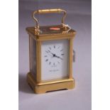 A BRASS CARRIAGE CLOCK, by Robert Blandford 1873, approximate height 14cm (key)