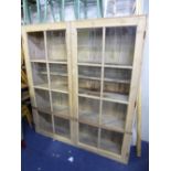 A LARGE PINE GLAZED TWO DOOR BOOKCASE, approximate size width 169cm x height 187cm x depth 36cm (sd,