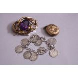 A VICTORIAN FANCY SCROLL DESIGN BROOCH, set with a large principle amethyst measuring