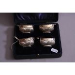 A CASED SET OF FOUR SILVER SALTS, of half reeded open boat form, Birmingham 1908, together with