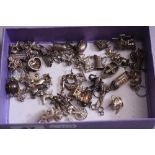 A BOX OF VARIOUS SILVER CHARMS, etc