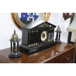 A BLACK MARBLE ARCHITECTURAL MANTEL CLOCK GARNITURE, having circular enamelled dial with Arabic