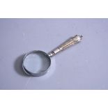 A SILVER HANDLED MAGNIFYING GLASS, having reeded repousse decoration, Sheffield 1992,