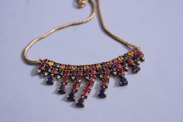 A 10CT GOLD NECKLACE, set with diamonds, rubies and sapphires, etc