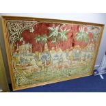 A LARGE WOVEN CARPET STYLE PICTURE, Camels with figures and buildings, approximate size including