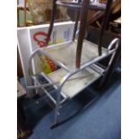 A CHROME FRAMED TROLLEY, with removable tray and two reproduction movie posters/pictures (3)