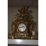 A BRASS CONTINENTAL MANTLE CLOCK, with gentleman on horse shaped finial, dial marked 'Walt', paper