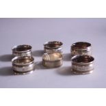 A SET OF FOUR LATE VICTORIAN CIRCULAR SILVER NAPKIN RINGS, rings engraved initial 'B' and foliate