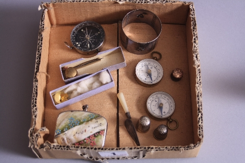 A BOX OF MISCELLANEOUS, to include three compasses, two thimbles, novelty silver bookmark moulded as