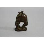 A SMALL CARVING, modelled as Horse with fly on back, height approximately 5.5cm