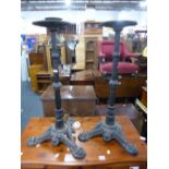 A PAIR OF BLACK PAINTED CAST IRON STANDS, with tripod bases