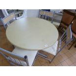 A METAL FRAMED CIRCULAR TABLE AND FOUR CHAIRS, (situated in cafe area)