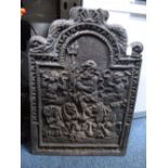 A CAST IRON FIRE BACK, with central figural detail