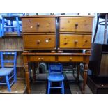 A PINE SIDE TABLE, with two drawers and a matching pair of two drawer bedside cabinets