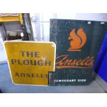 A METAL PUB SIGN, reading 'Ansells, Temporary Sign' and another metal sign reading 'The Plough,