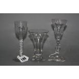 A FACETED STEM WINE GLASS, having ogee bowl on plain circular foot, approximately 15cm high, an