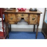 A REGENCY MAHOGANY SMALL SIDEBOARD, the central small drawer above twin quarter shell motifs flanked