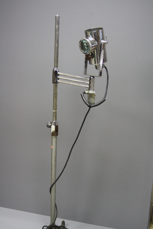 A VINTAGE MEDICAL LAMP ON A CAST BASE, with chromed upper extension tube and head, the lamp has a