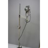A VINTAGE MEDICAL LAMP ON A CAST BASE, with chromed upper extension tube and head, the lamp has a