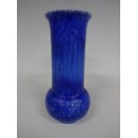 A RUSKIN POTTERY VASE, having long cylindrical flared neck rim to bulbous body, blue mottled