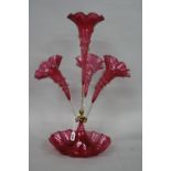 A VICTORIAN CRANBERRY GLASS EPERGNE, the four wavy rimmed flutes over a circular base, overall