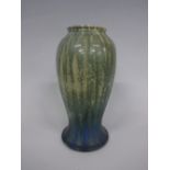 A RUSKIN POTTERY BALUSTER VASE, on flared foot having graduating blue to green mottled matt glaze,