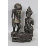 TRIBAL ART, two African carved wooden figures, one standing, bird style face, hands clutching a