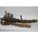 TRIBAL ART, three carved wood dragon boats, with figures and oars, two of the boats on later stands,