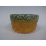 A RUSKIN POTTERY JARDINIERE, of plain form having green and orange tonal crystalline glaze,