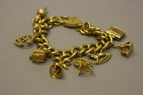 A LATE 20TH CENTURY 9CT GOLD CURB LINK CHARM BRACELET, together with assorted 9ct gold charms,