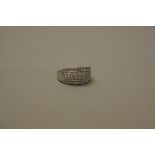 A MODERN WHITE GOLD AND DIAMOND WIDE BAND DRESS RING, total diamond weight approximately 0.60ct,