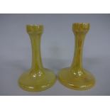 TWO RUSKIN POTTERY CANDLESTICKS, having swept circular foot supporting tapering column with