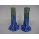 TWO RUSKIN POTTERY CANDLESTICKS, of tapering hexagonal form in graduating blue to green mottled matt