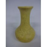 A RUSKIN POTTERY GLOBE AND SHAFT VASE, having flared neck, relief moulded trailing floral and