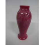 A RUSKIN POTTERY BALUSTER VASE, on circular foot with short neck, in red mottled glaze, impressed