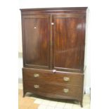 A 19TH CENTURY MAHOGANY LINEN PRESS, having stepped cornice double panelled doors opening to three