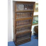 A GLOBE WERNICKE WALNUT LEAD GLAZED FIVE SECTION BOOKCASE, with cornice and lower drawer,