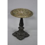 A COALBROOKDALE TRIVET, the pierced brass circular top with floral detail with registration mark and